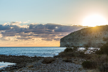 Sunset at Cyprus Beach: Pastel Colors, Clouds over the Sea, Rocky Cliff