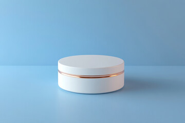 White container with gold stripe on lid, surrounded by colorful autumn leaves on table.