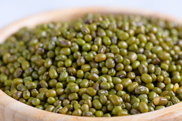Rustic bowl of dried mung beans closeup. Healthy plant-based protein, healthy cooking ingredient for vegan recipes and vegetarian diets