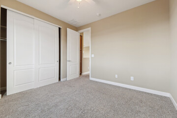 Spacious living room with wooden flooring and sliding doors leading to a bright outdoor area