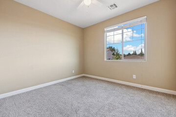 Spacious living room with wooden flooring and sliding doors leading to a bright outdoor area