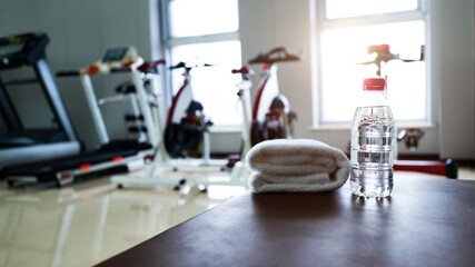 Water and towels on the gym bench