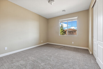 Spacious living room with wooden flooring and sliding doors leading to a bright outdoor area