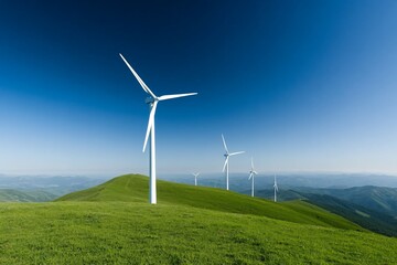 Wind turbines on a green hilltop under a clear blue sky.
