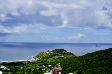 Fototapeta premium Guana Bay on the east side of St. Maarten is calm on this overcast day, with Pelican Key visible on the right.