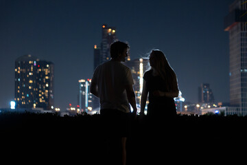 a couple in the city at night 