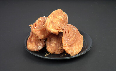 Fresh khaja of puri is put in black background