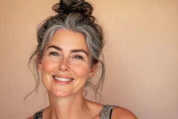Smiling middle-aged woman with natural gray hair and a joyful expression. Generated AI