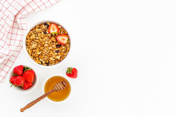 Flat lay of oatmeal granola and ingredients served on white table. Healthy breakfast