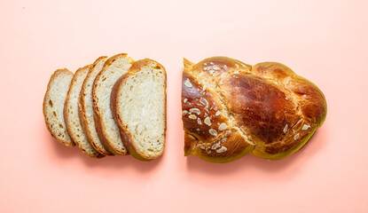 Easter bread, greek tsoureki braid on pink color, top view