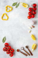Cooking concept with tomatoes and chili peppers, vegetables spices on the kitchen desk top