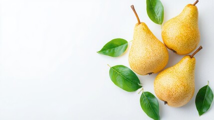 Three ripe yellow pears with green leaves on white background.