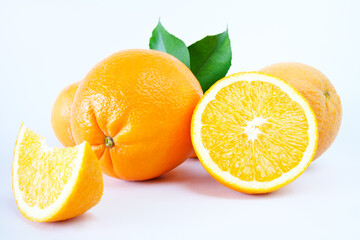 Fresh oranges with slices isolated on white background