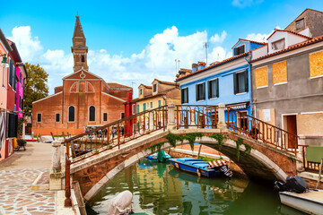 Colorful houses in Burano near Venice, Italy with boats. Famous tourist attraction in Venice....