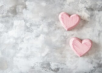 Fototapeta premium Light pink wooden hearts placed on a textured gray background with ample copy space, creating a simple and romantic design. Ideal for Valentine's Day, love themes, and minimalist designs