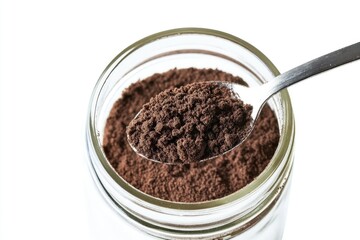 A spoon with a generous amount of cocoa powder on a jar, perfect for baking or cooking