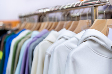Colorful hoodies hanging on the store