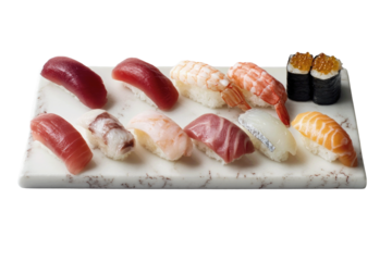 A marble platter displays a variety of sushi including tuna, salmon, shrimp, and other seafood.  Two additional pieces of gunkan maki are included.