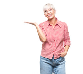 Obraz premium Woman holding free advertising space for your product on his palm, isolated on white background. Happy promoter middle aged woman, copy space for text.