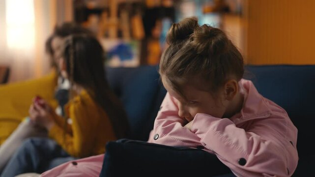 Unhappy girl feels sad as her best friends gossip near her, feeling left out