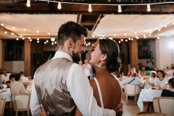 the first dance of the bride and groom inside a restaurant