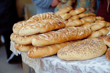 Various types of bread displayed on a table, ideal for food styling or education purposes