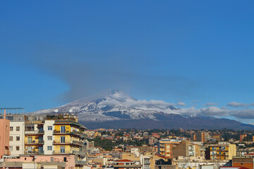Mount Etna volcano and city, december. Catania, Sicily, Italy