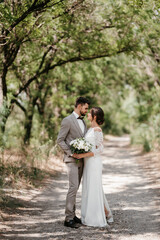 Fototapeta premium guy and a girl newlyweds are walking in the forest