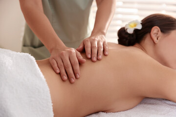 Woman receiving massage in spa salon, closeup