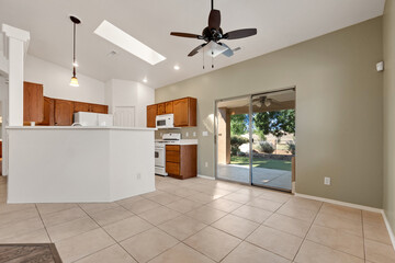 Spacious living room with wooden flooring and sliding doors leading to a bright outdoor area