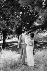 guy and a girl newlyweds are walking in the forest
