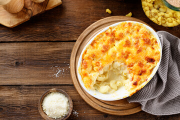 Homemade Fresh Baked Creamy Macaroni and Cheese, Pasta in a Baking Dish. Wooden background, top view