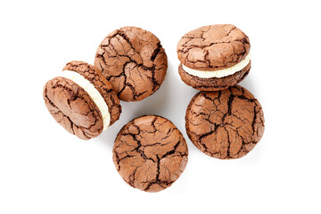 Chocolate sandwich cookies, brownie biscuits with  cream cheese filling isolated on white background, top view