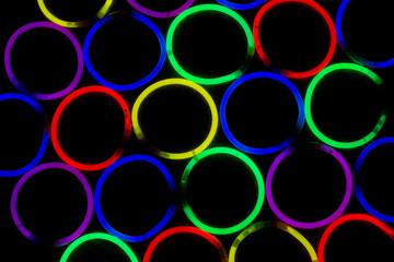 Neon glow sticks arranged in circles shinning in the dark