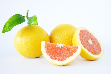 Fresh grapefruits with slices isolated on a white background