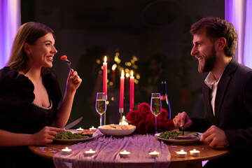 Couple of lovers having romantic dinner in restaurant, talking, dating and celebrating Valentine's day, side view shot