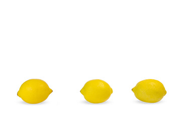 Three fresh lemons lie on a white background.