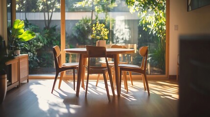 Sunlit dining room with wooden table and chairs, overlooking a lush garden.