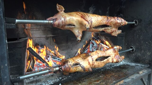 Pigs being grilled slowly on spit in traditional way in Bosnia and Herzegovina
