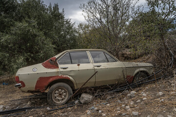 scaraped car on the side of a street