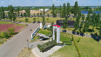 Large military tank is on display in a grassy field