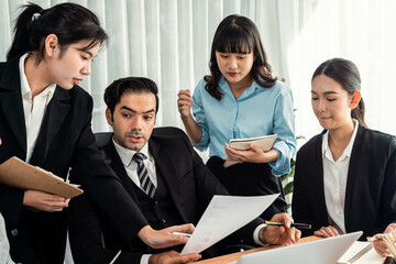 Diverse of business people from various ethnic group working in modern office environment. Productive and multi ethnic office workers engage in discussion for strategic business marketing. Meticulous