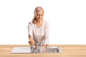 Woman pouring a glass of tap water