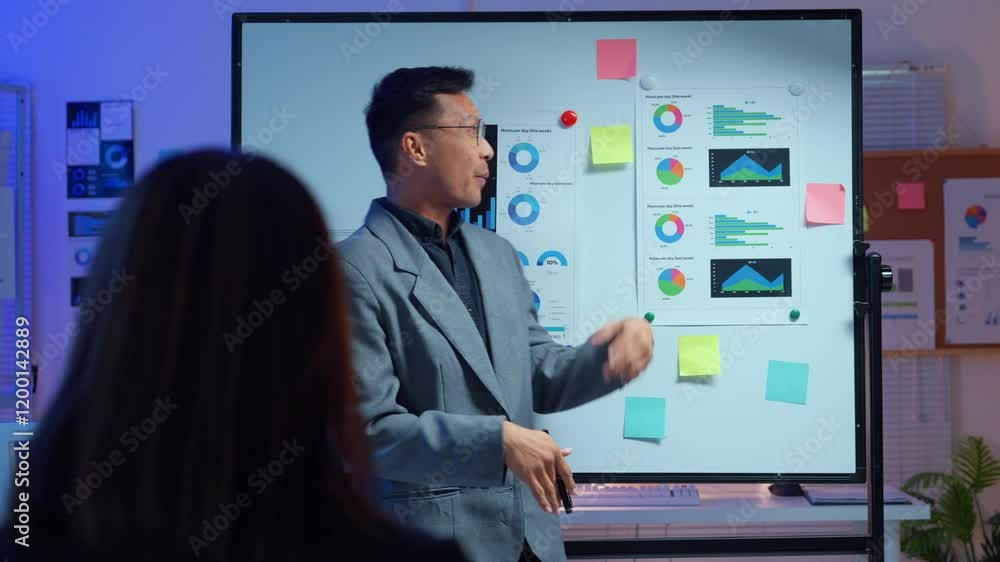 Poster confident marketing professional analyzing business data on whiteboard while collaborating with coll