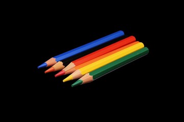 Fototapeta premium Colorful colored pencils on a black background, top view A black and rainbow color design for a school or art studio advertisement Generative AI