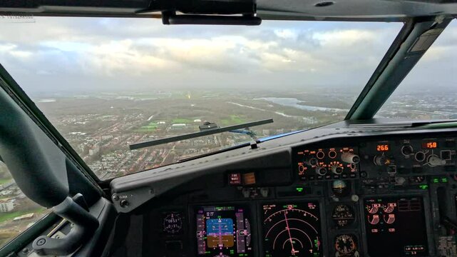 Cockpit pilot view during landing of airplane on runway at Schiphol Amsterdam Airport