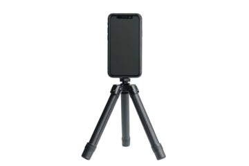Smartphone mounted on tripod for stable photography or video recording setup in a home or studio environment