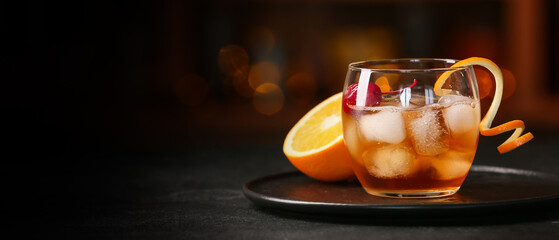 Glass of tasty Old Fashioned Cocktail on table in bar
