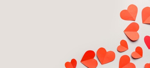 Red paper hearts on grey background with space for text. Valentine's Day celebration
