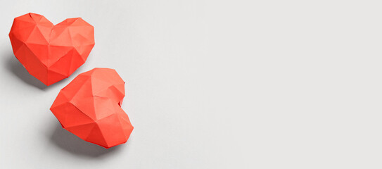 Red hearts made of paper on grey background. Valentine's Day celebration